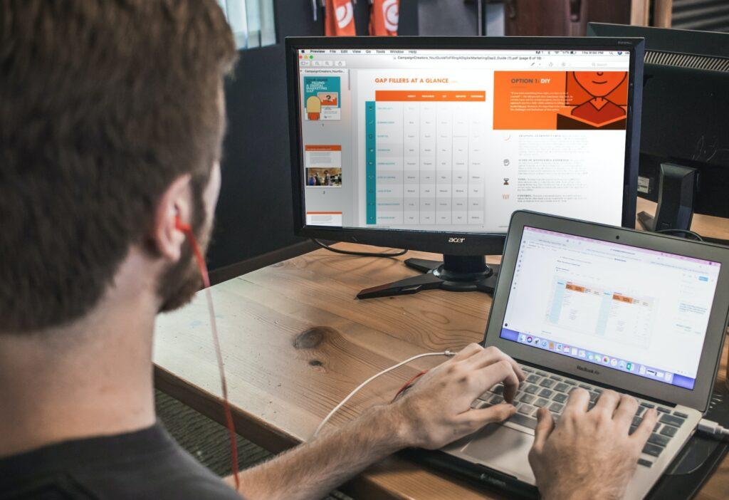 Man Types on Laptop While Working