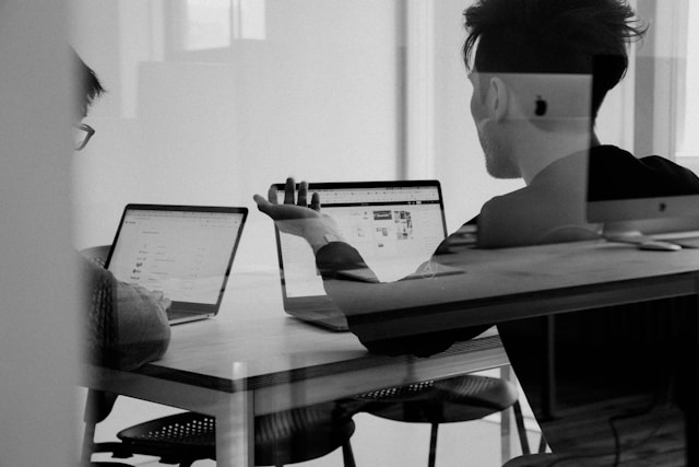 man using MacBook in an office
