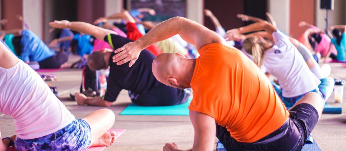 People in a Yoga Class Stretch